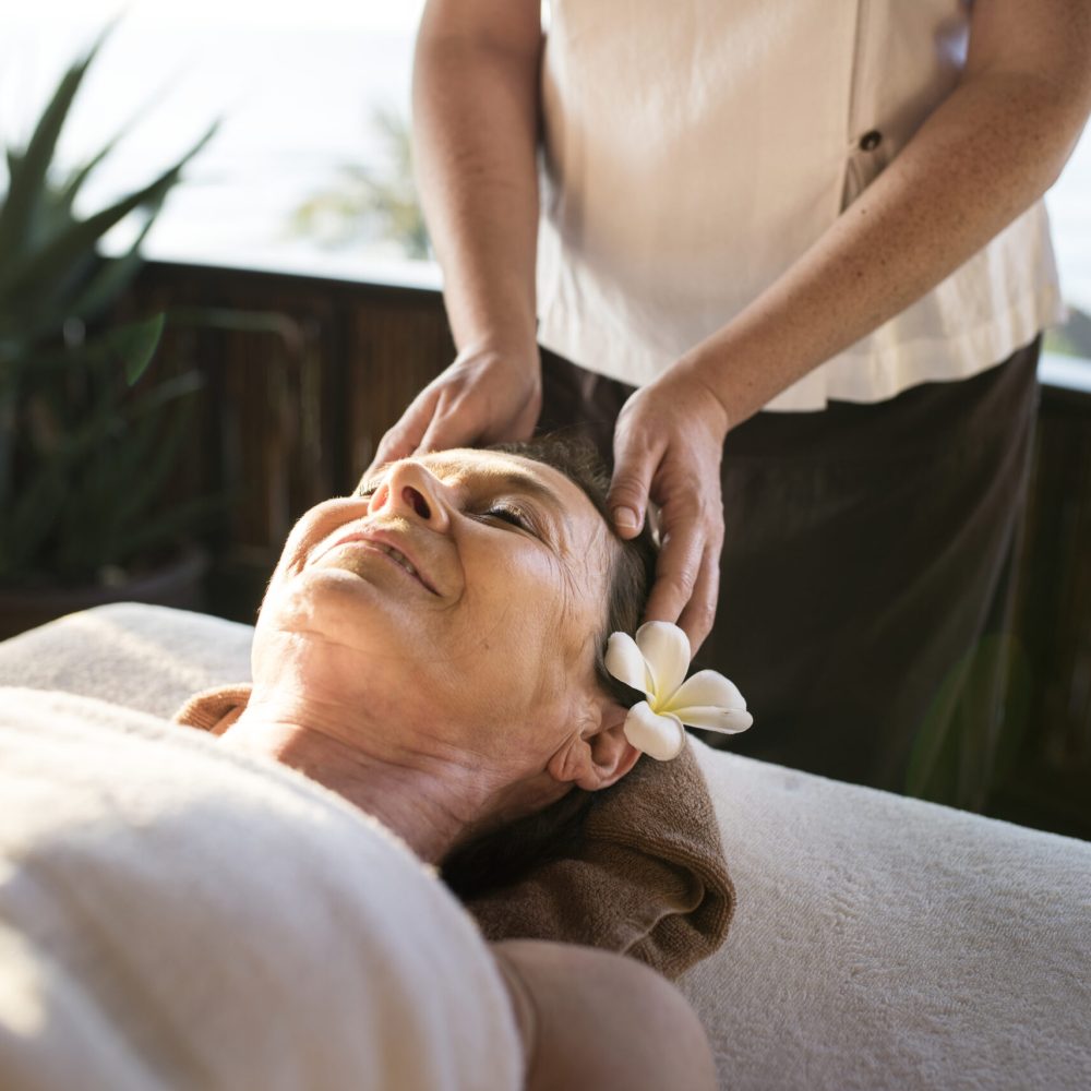 Female message therapist giving a massage at a spa